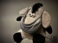 Donkey puppet wearing mask side view